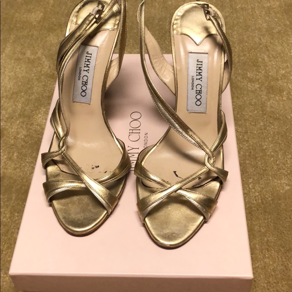 Jimmy Choo gold strapped heels.